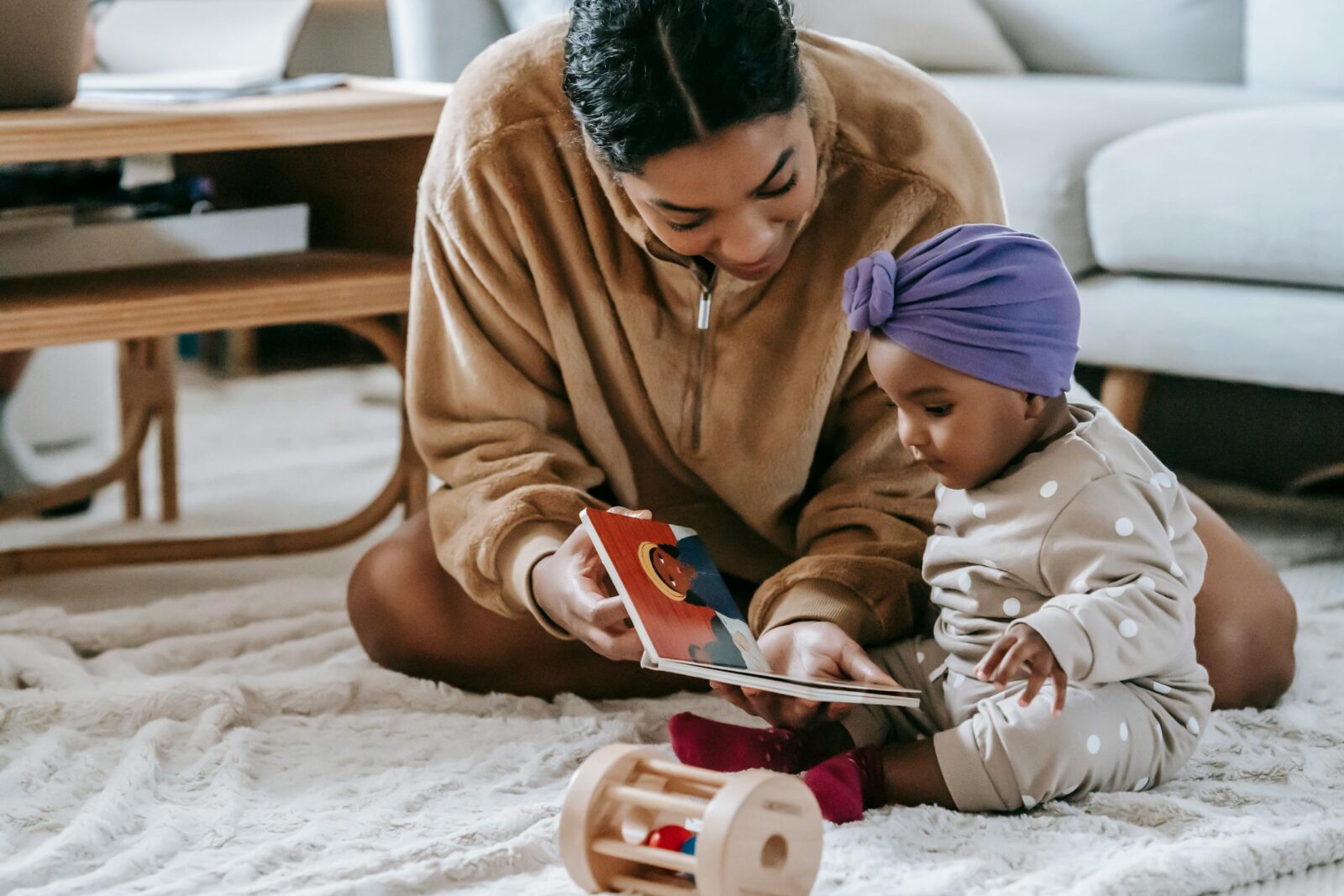 Mother reading a picture book with her baby